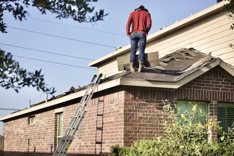 Professional roofer working on a residential roof in Wood Springs